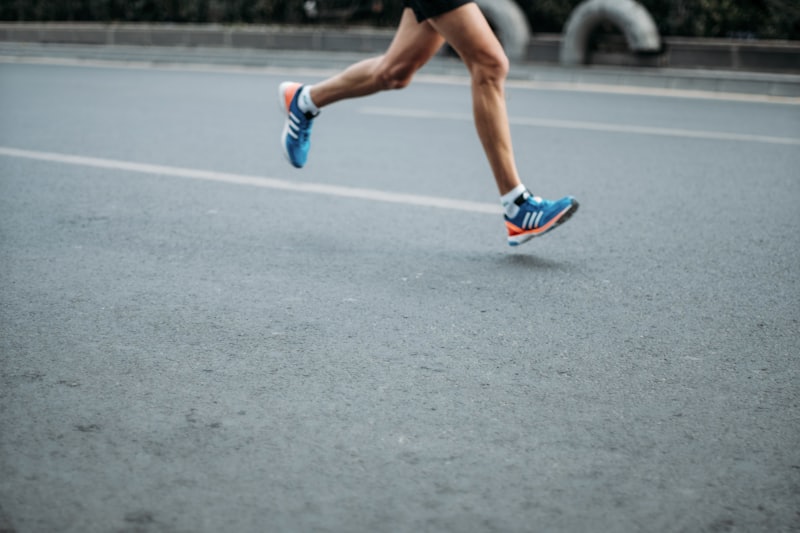Runner mid-stride on a road