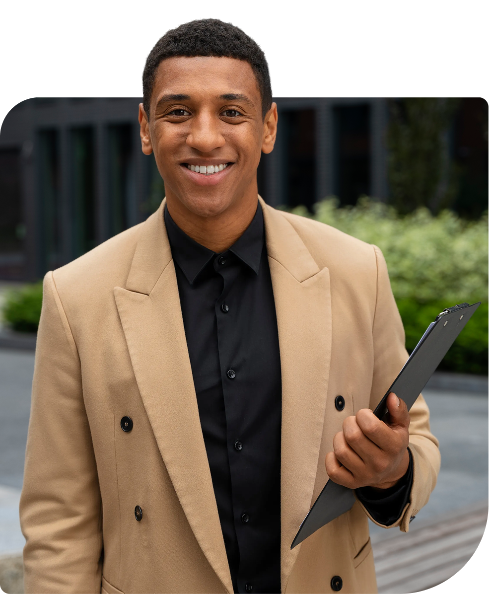 A smiling employee holding a clipboard outdoors